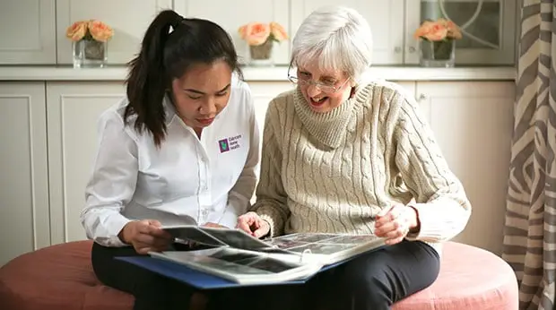 An Eldercare nurse answering questions with a family